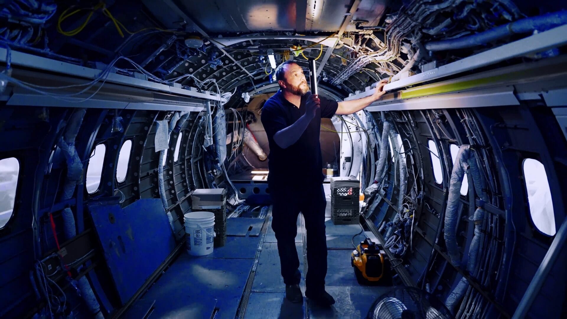 Photograph of an AME performing fuselage inspection