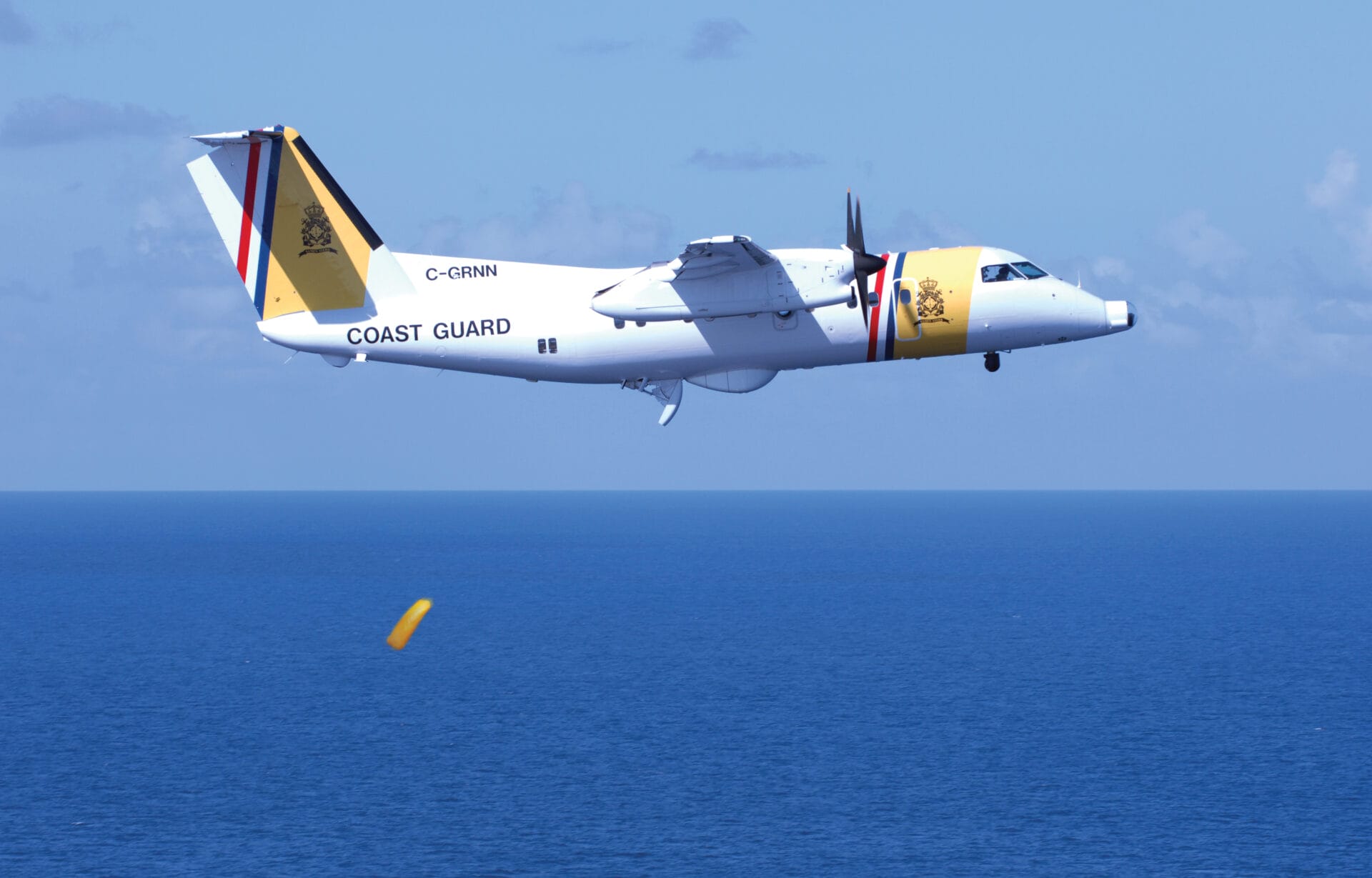 Image of DCCG aircraft dropping life raft