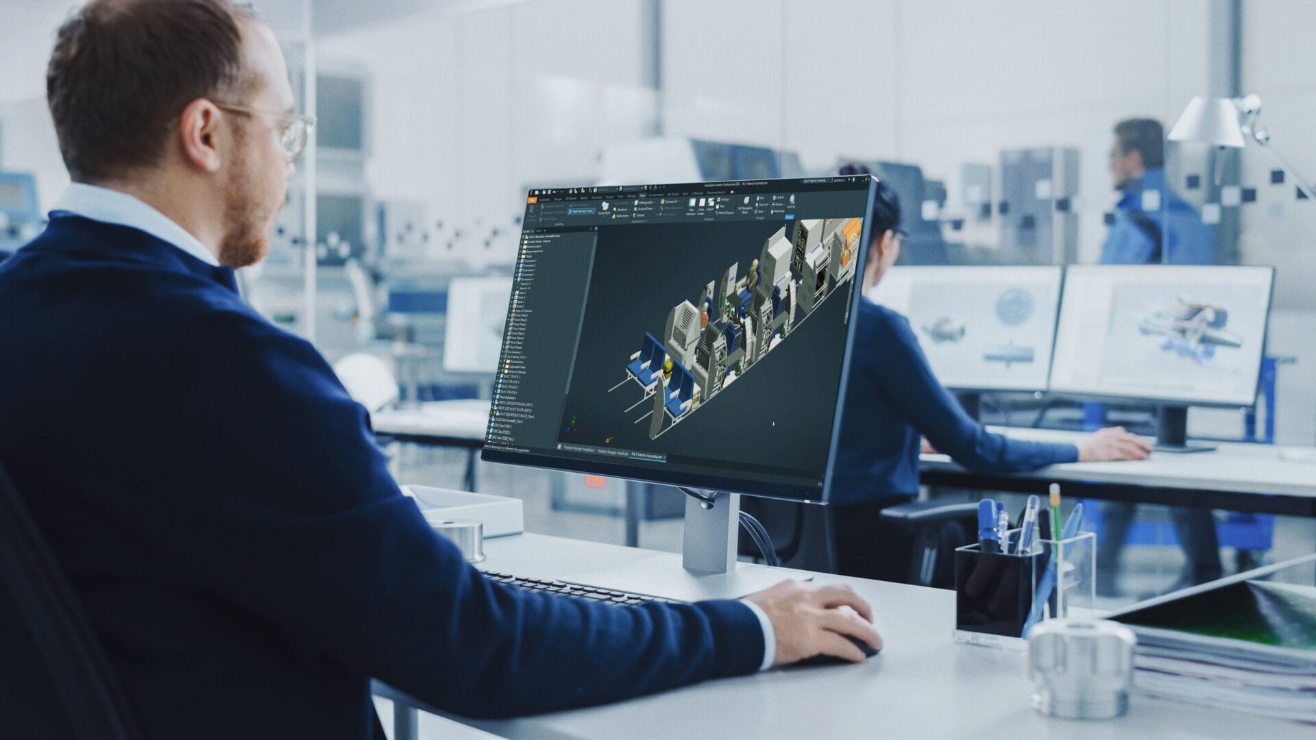man using computer to edit CAD model of aircraft interior